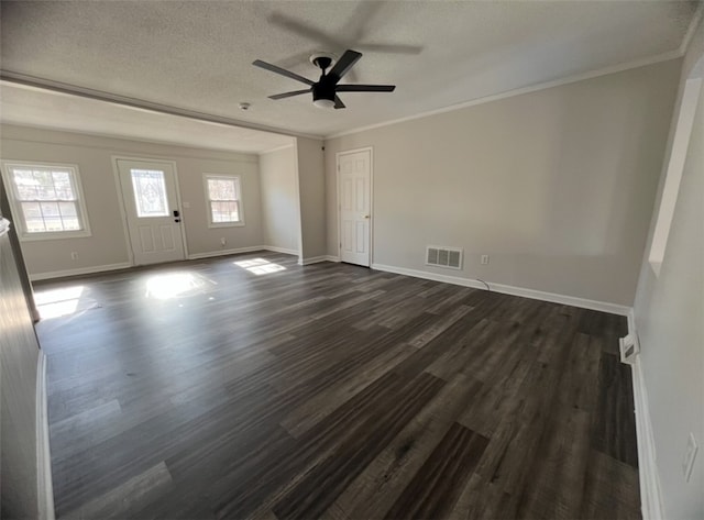 empty room featuring a textured ceiling, dark hardwood / wood-style flooring, ceiling fan, and crown molding