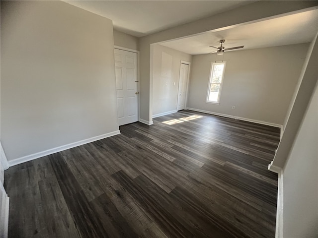 interior space with ceiling fan and dark hardwood / wood-style flooring