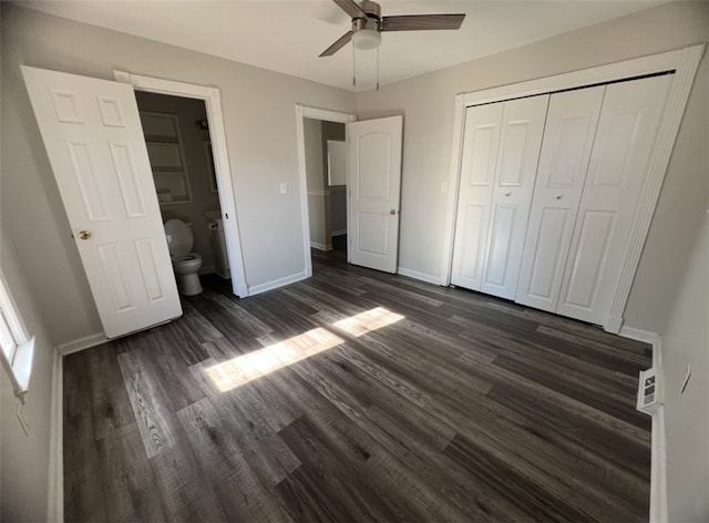 unfurnished bedroom featuring ensuite bathroom, a closet, ceiling fan, and dark hardwood / wood-style floors