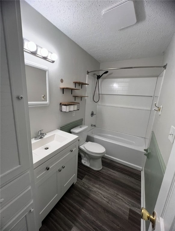 full bathroom with a textured ceiling, toilet, shower / tub combination, vanity, and hardwood / wood-style flooring