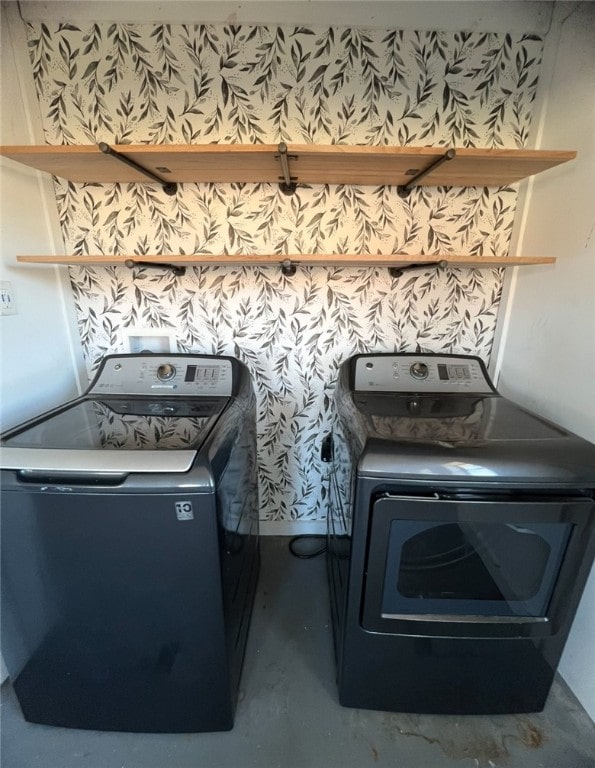 clothes washing area featuring separate washer and dryer