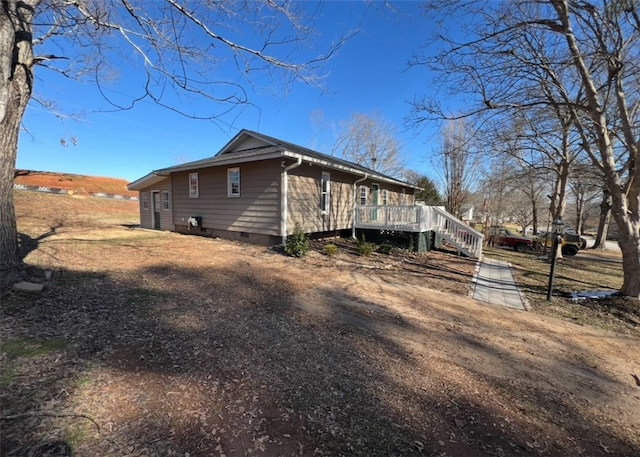 view of side of home with a wooden deck