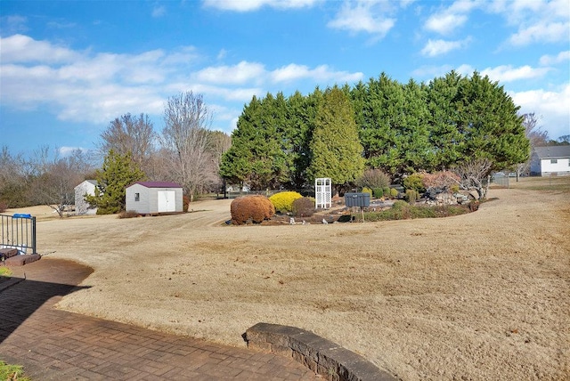 view of yard with an outbuilding and a shed