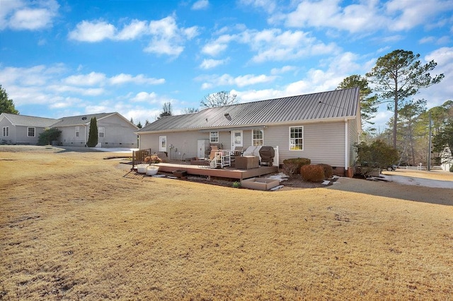 rear view of property featuring a wooden deck, metal roof, and crawl space