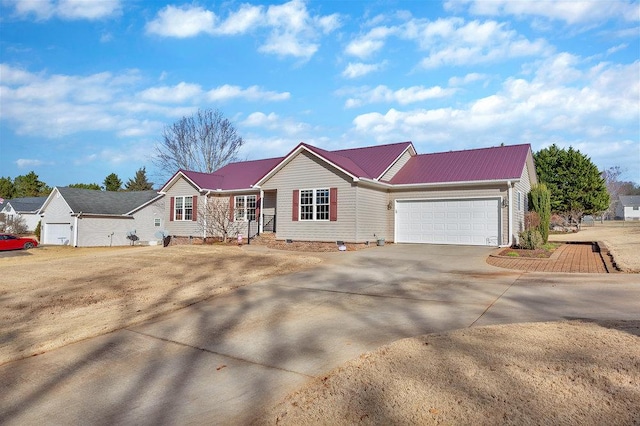 single story home featuring crawl space, a garage, driveway, and metal roof