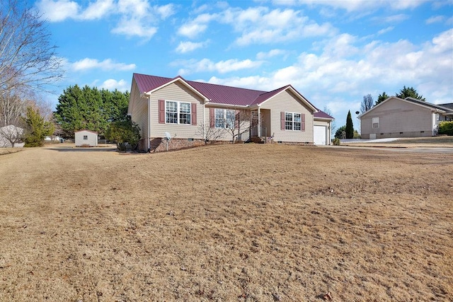 single story home with an attached garage, metal roof, and crawl space