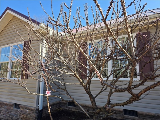 view of side of home featuring crawl space