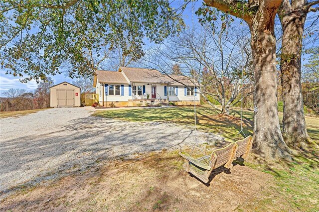 ranch-style home with a shed and a front yard