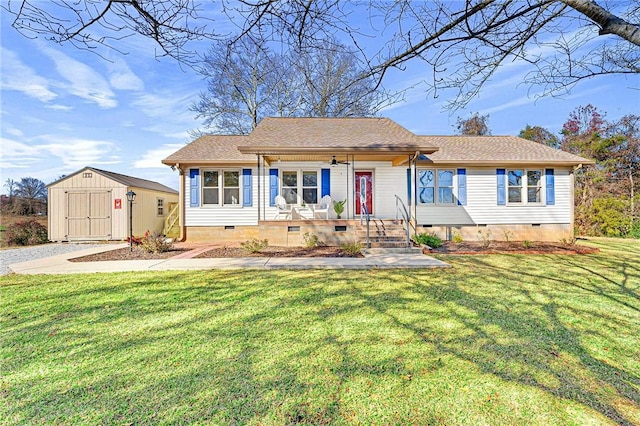 view of front of house featuring covered porch, a shed, and a front yard