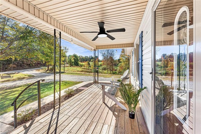 deck with ceiling fan and covered porch