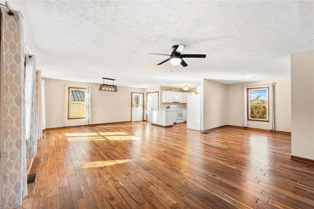 unfurnished living room with a textured ceiling, light hardwood / wood-style floors, and ceiling fan