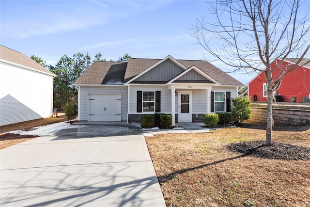 view of front of property with a garage and a front lawn