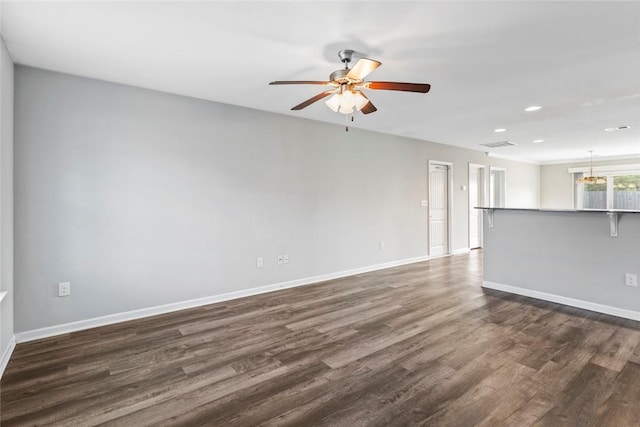 unfurnished living room with ceiling fan and dark wood-type flooring