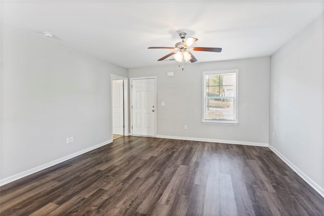 empty room with dark hardwood / wood-style floors and ceiling fan