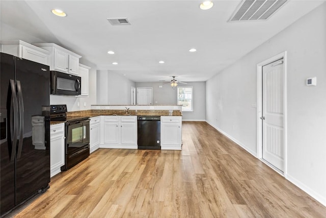 kitchen featuring ceiling fan, sink, kitchen peninsula, white cabinets, and black appliances