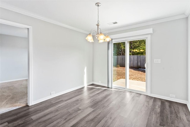 unfurnished dining area featuring crown molding, dark hardwood / wood-style floors, and an inviting chandelier