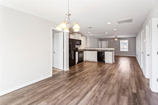 kitchen featuring white cabinetry, kitchen peninsula, decorative light fixtures, black appliances, and ceiling fan with notable chandelier