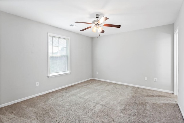 carpeted spare room featuring ceiling fan