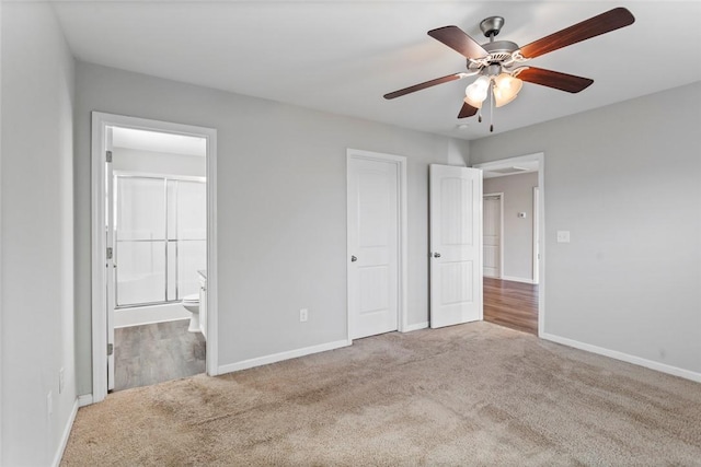 unfurnished bedroom with carpet floors, ensuite bathroom, and ceiling fan