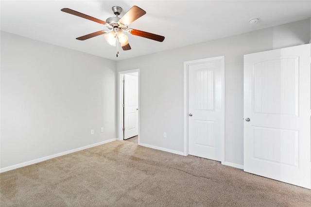 unfurnished bedroom featuring ceiling fan and light colored carpet