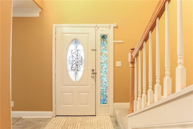 foyer featuring crown molding