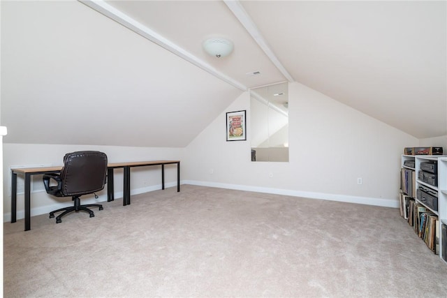 carpeted home office featuring vaulted ceiling