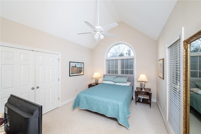 carpeted bedroom featuring vaulted ceiling, ceiling fan, and a closet