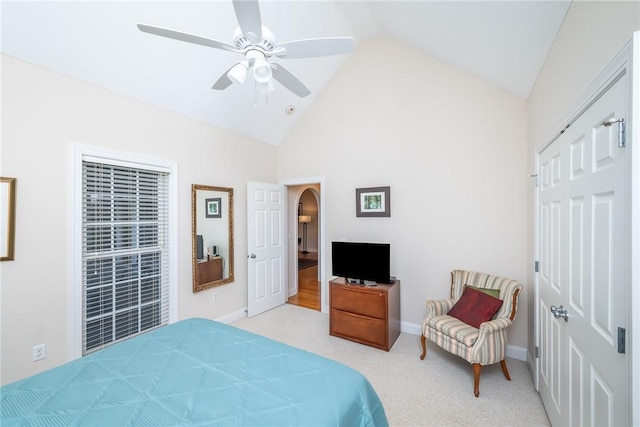 bedroom featuring ceiling fan, light colored carpet, and lofted ceiling