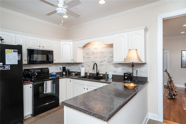 kitchen with black appliances, kitchen peninsula, ornamental molding, white cabinets, and sink