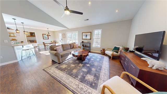 living room with high vaulted ceiling, ceiling fan, and dark wood-type flooring