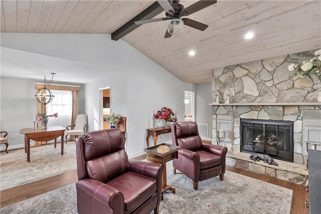 living room featuring ceiling fan with notable chandelier, a fireplace, wooden ceiling, and hardwood / wood-style floors