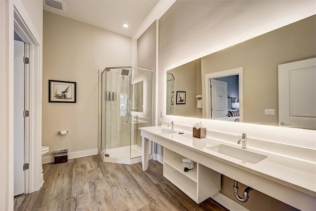 bathroom with toilet, wood-type flooring, walk in shower, and vanity