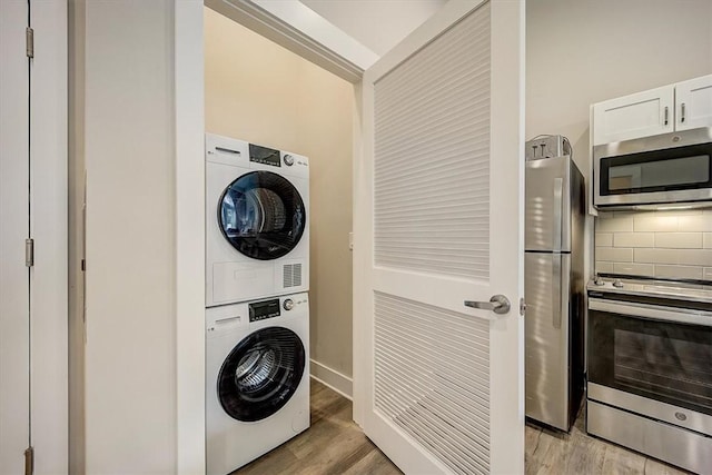 washroom featuring light wood-type flooring and stacked washer and dryer