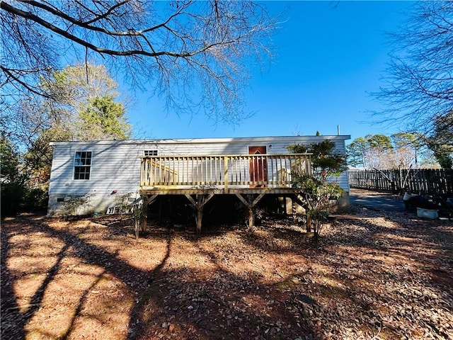 rear view of property featuring a wooden deck