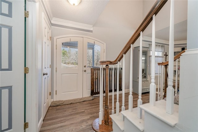 entrance foyer with hardwood / wood-style floors, a textured ceiling, french doors, and plenty of natural light