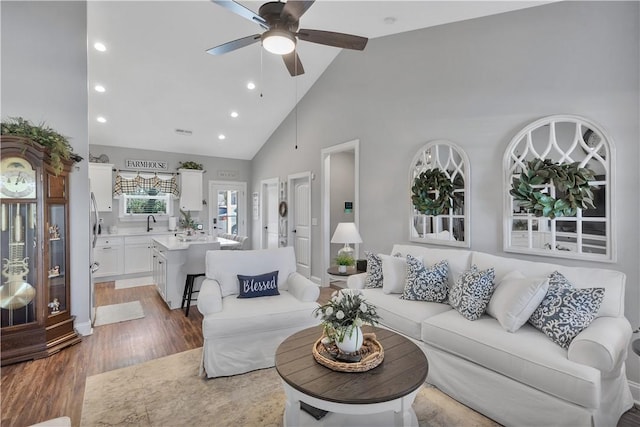 living room featuring high vaulted ceiling, ceiling fan, and dark hardwood / wood-style flooring