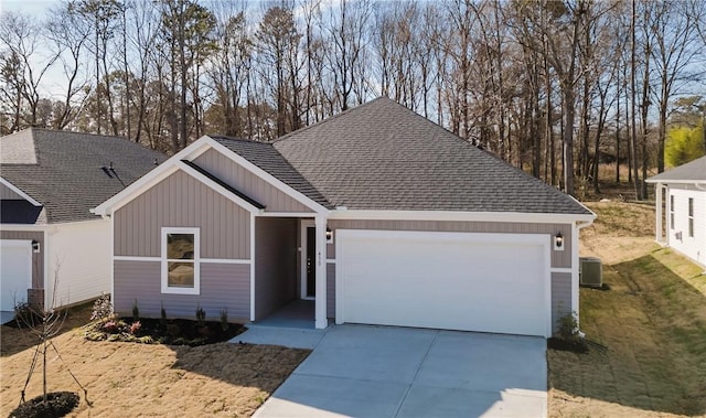 view of front facade with a garage and central AC