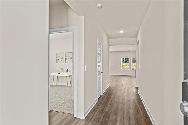 hallway with hardwood / wood-style flooring