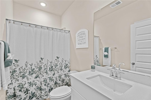 bathroom with toilet and vanity