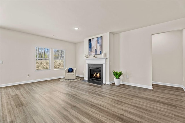 unfurnished living room featuring hardwood / wood-style flooring