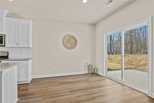 unfurnished dining area featuring light hardwood / wood-style floors