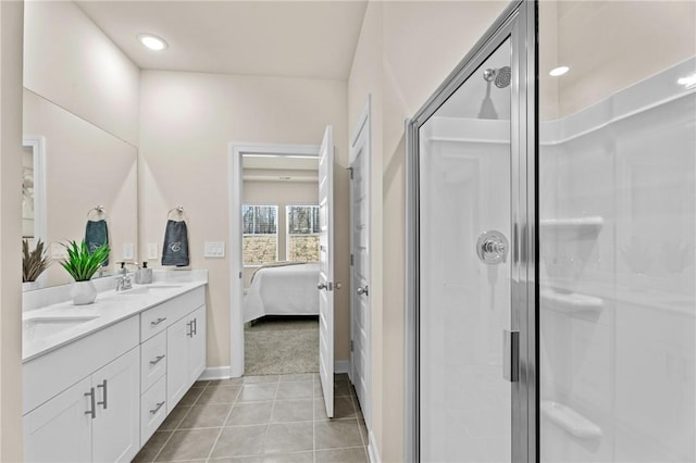 bathroom with tile patterned flooring, an enclosed shower, and vanity