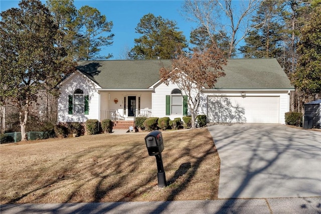 view of front of home featuring covered porch, a front lawn, and a garage