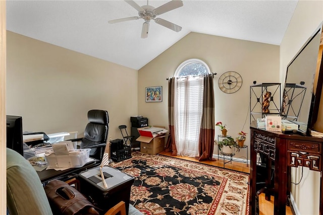 home office featuring ceiling fan, vaulted ceiling, and wood-type flooring