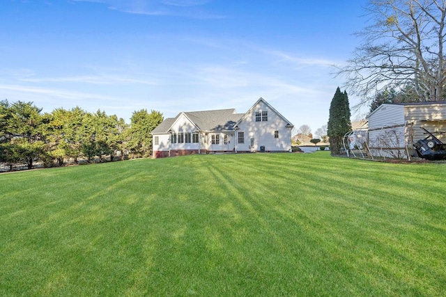 rear view of property featuring a yard