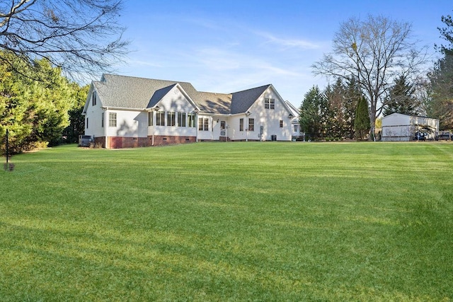 back of property with crawl space and a lawn