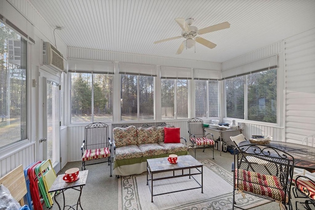 sunroom / solarium featuring ceiling fan and an AC wall unit