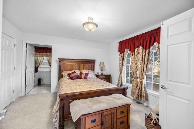 bedroom with light carpet and baseboards