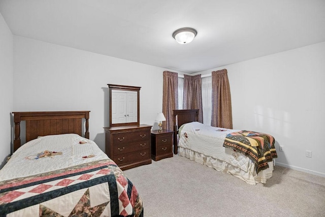 bedroom with carpet floors and baseboards