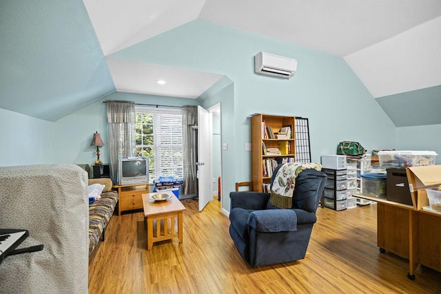 living area featuring lofted ceiling, a wall mounted air conditioner, and wood finished floors